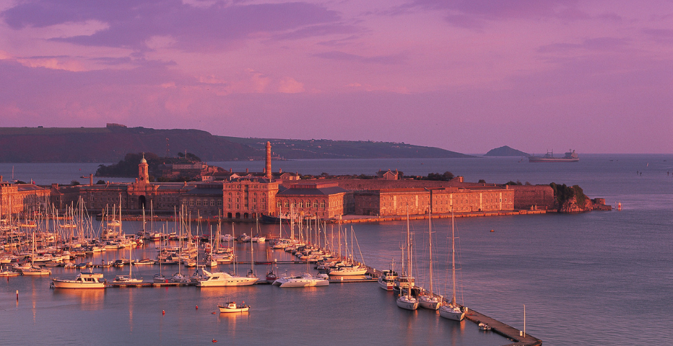 An aerial shot of the Royal William Yard with sea in the background